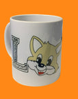 A white ceramic mug with 'LOVE' printed on it, featuring a cartoon cat's face peeking around the letter 'L'.