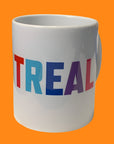 White mug with "MONTREAL" in colorful letters on a white background