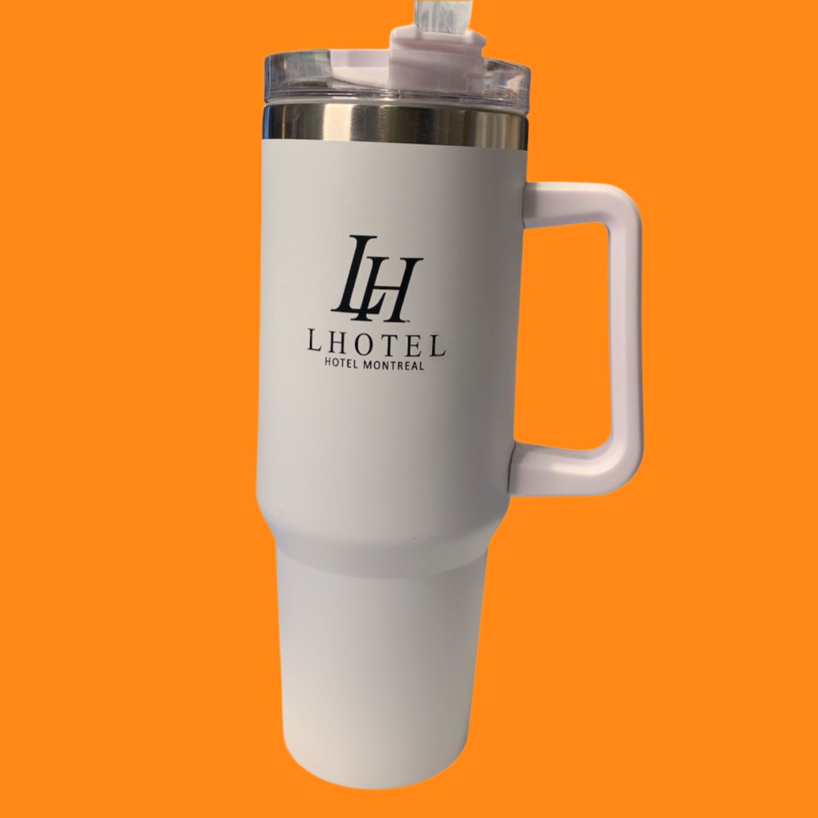 A white plastic water quencher with a pink handle and the LHotel Montreal logo, equipped with a straw.