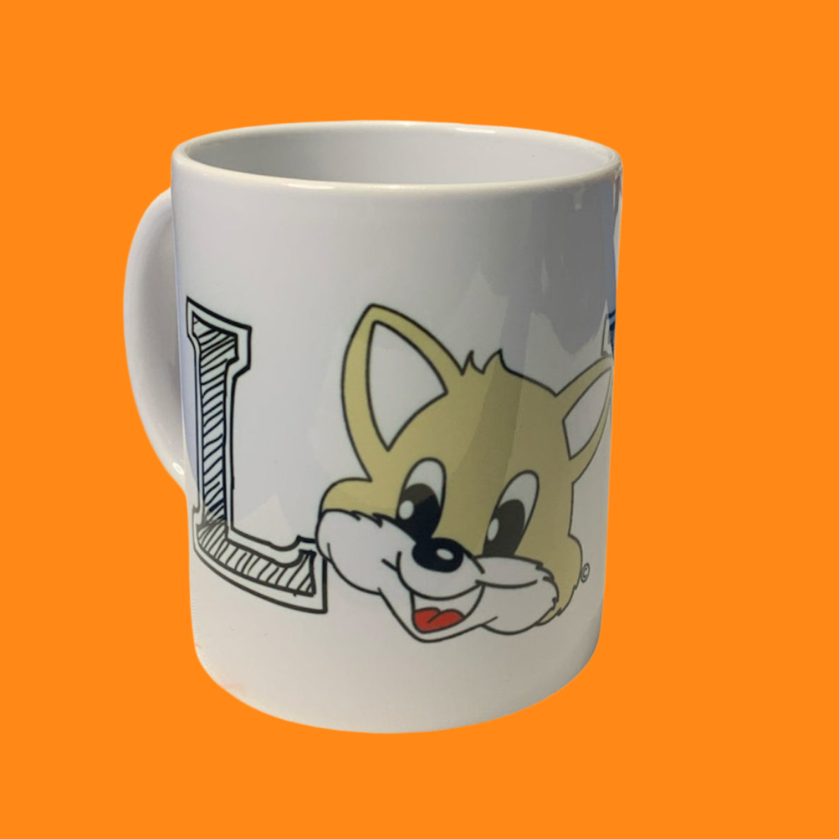 A white ceramic mug with 'LOVE' printed on it, featuring a cartoon cat's face peeking around the letter 'L'.