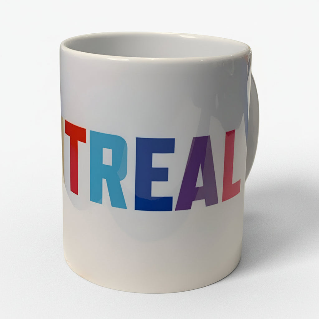 White mug with "MONTREAL" in colorful letters on a white background