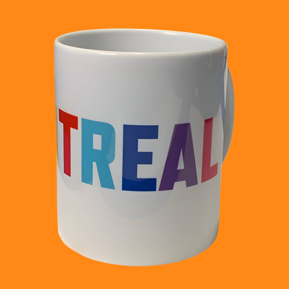 White mug with "MONTREAL" in colorful letters on a white background
