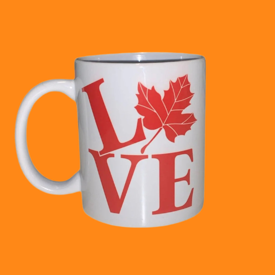 White mug with red 'LOVE' design featuring a maple leaf on a white background